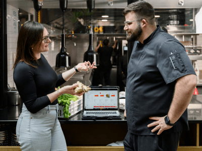 Une commerciale et un chef cuisinier échangent en cuisine